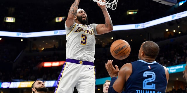 Los Angeles Lakers forward Anthony Davis (3) dunks against Memphis Grizzlies forward Xavier Tillman (2) during Game 1 of a first-round NBA basketball playoff series Sunday, April 16, 2023, in Memphis, Tenn.