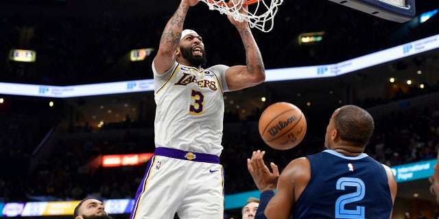Los Angeles Lakers forward Anthony Davis (3) dunks against Memphis Grizzlies forward Xavier Tillman (2) during Game 1 of a first-round NBA basketball playoff series Sunday, April 16, 2023, in Memphis, Tenn.