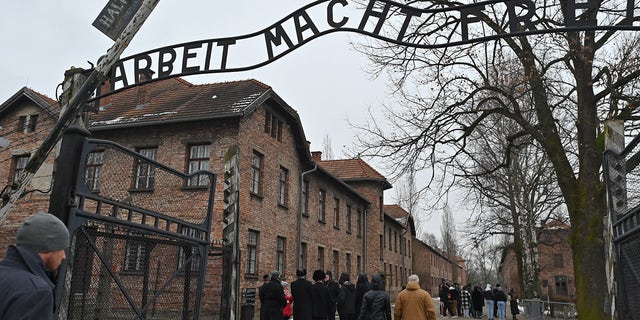 Visitors are seen inside the former Auschwitz I camp in Oswiecim, Poland, on January 27, 2023.