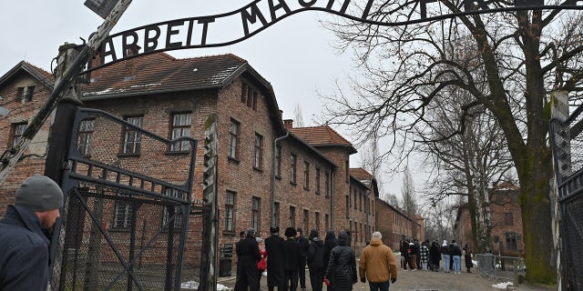 Visitors are seen inside the former Auschwitz I camp in Oswiecim, Poland, on January 27, 2023.