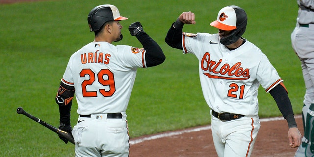 Austin Hays #21 of the Baltimore Orioles celebrates with Ramon Urias #29 after hitting a home run against the Oakland Athletics during the sixth inning at Oriole Park at Camden Yards on April 10, 2023 in Baltimore, Maryland.