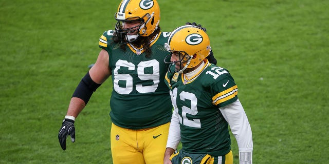 David Bakhtiari (69) and Aaron Rodgers (12) of the Green Bay Packers celebrate after scoring a touchdown in the second quarter against the Jacksonville Jaguars at Lambeau Field on November 15, 2020 in Green Bay, Wisconsin.