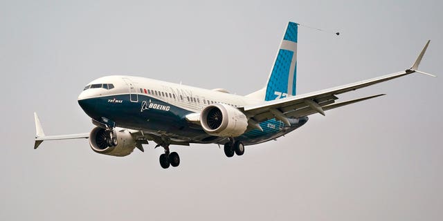 A Boeing 737 Max jet, piloted by Federal Aviation Administration Chief Steve Dickson, prepares to land at Boeing Field following a test flight in Seattle.