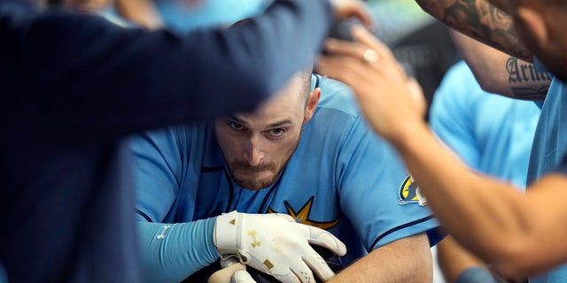 Tampa Bay Rays' Brandon Lowe celebrates in the dugout after hitting a grand slam off Oakland Athletics starting pitcher James Kaprielian on Sunday, April 9, 2023, in St. Petersburg.