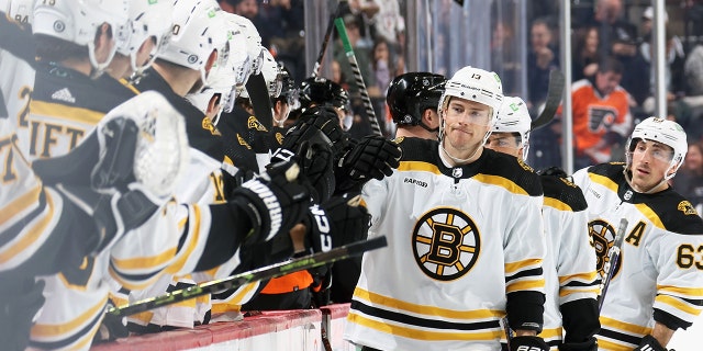 Charlie Coyle celebrates his first-period goal against the Flyers with his Boston Bruins teammates at the Wells Fargo Center on April 9, 2023, in Philadelphia.