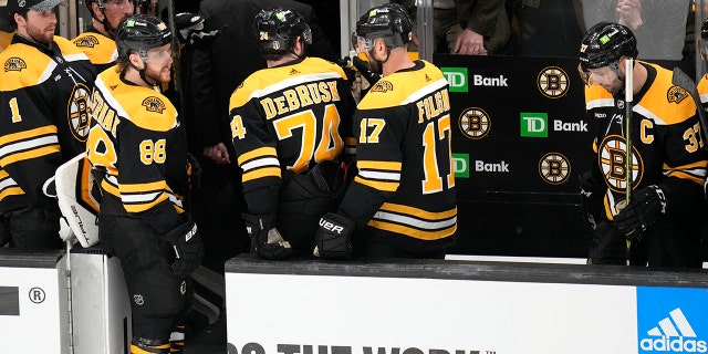 Bruins players walk off the ice