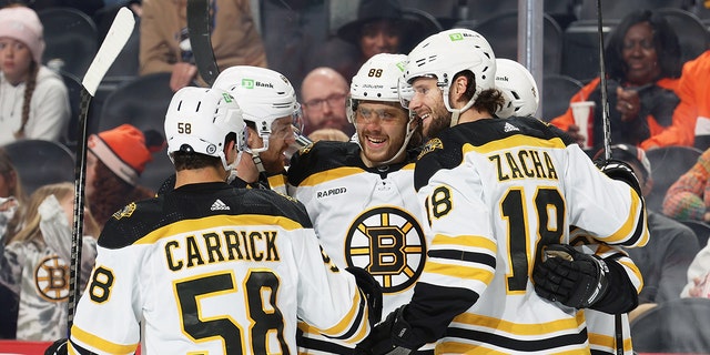 David Pastrnak and his Boston Bruins teammates celebrates the second of his two second-period goals against the Flyers at the Wells Fargo Center on April 9, 2023, in Philadelphia.