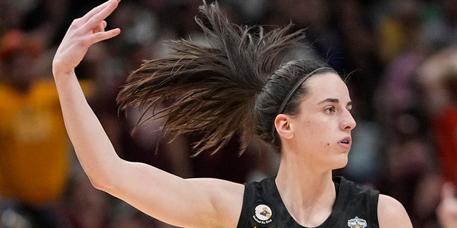 Iowa's Caitlin Clark reacts after a three-pointer against South Carolina during the NCAA Women's Final Four semifinals, Friday, March 31, 2023, in Dallas.