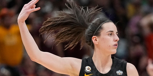 Iowa's Caitlin Clark reacts after a three-pointer against South Carolina during the NCAA Women's Final Four semifinals, Friday, March 31, 2023, in Dallas.