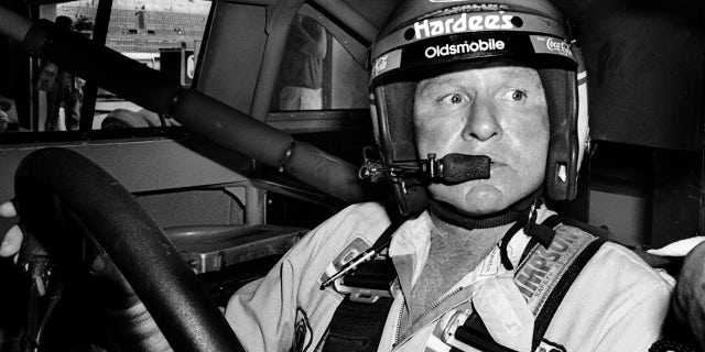 Cale Yarborough sits in his car prior to the start of the 1986 Pepsi Firecracker 400 stock car race at Daytona International Speedway in Florida.