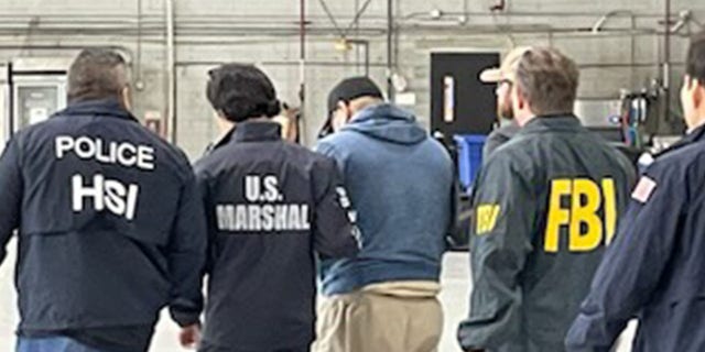 Jorge Ivan Gastelum Avila with HSI, FBI, and U.S. Marshals agents. 