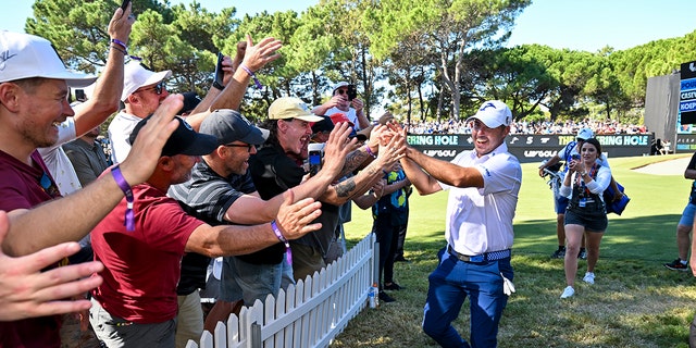 Chase Koepka high-fives fans