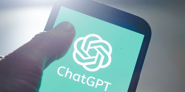 ChatGPT on a smart phone with man's thumb