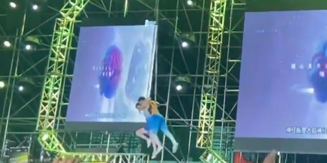 Chinese acrobat couple lifted off the ground