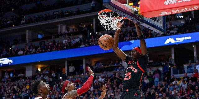 Chris Boucher #25 of the Toronto Raptors scores on a dunk in the first half against the Denver Nuggets at Ball Arena on March 6, 2023 in Denver, Colorado.