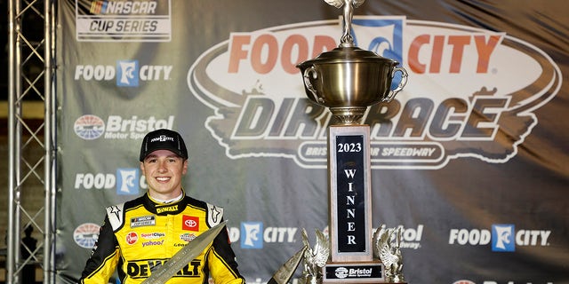 Christopher Bell, driver of the #20 Toyota DeWalt Power Stack, celebrates in victory lane after winning the NASCAR Cup Series Food City Dirt Race at Bristol Motor Speedway on April 9, 2023 in Bristol, Tennessee.