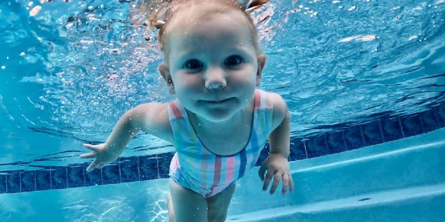 Claire Scarnati swims underwater with her mother, swim instructor Nikki Scarnati, nearby. Nikki Scarnati said she advises parents to use layers of protection when it comes to children and water safety.