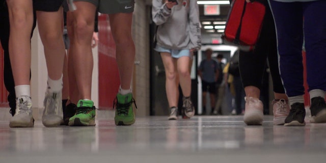 High school students walk down the hallway