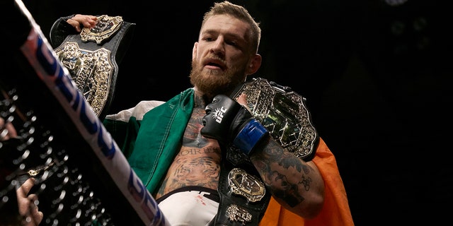Conor McGregor holds the belts