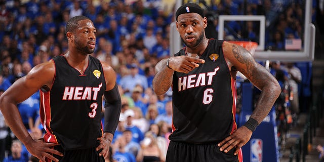 Dwyane Wade and LeBron James talk during a game