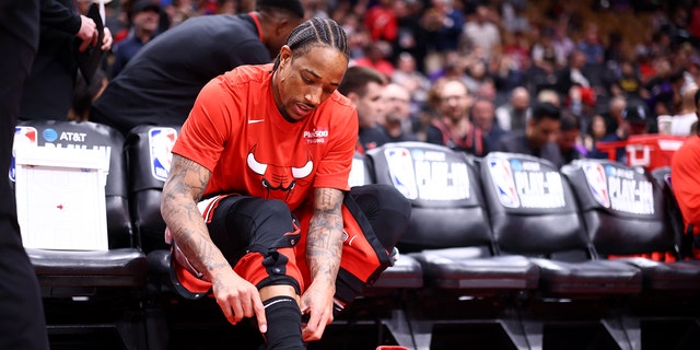 DeMar DeRozan of the Chicago Bulls puts on his sneakers before a game against the Toronto Raptors during the 2023 play-in tournament April 12, 2023, at the Scotiabank Arena in Toronto.