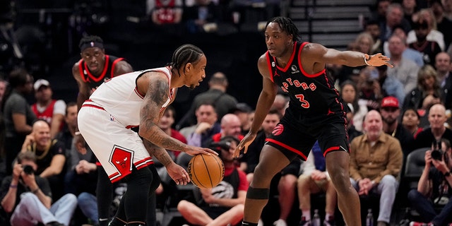 DeMar DeRozan of the Chicago Bulls dribbles the ball against O.G. Anunoby of the Raptors during the Play-In Tournament at the Scotiabank Arena on April 12, 2023, in Toronto.