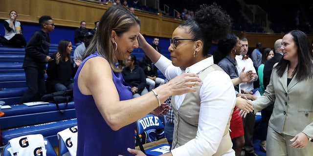 Coach DeUnna Hendrix hugs another coach