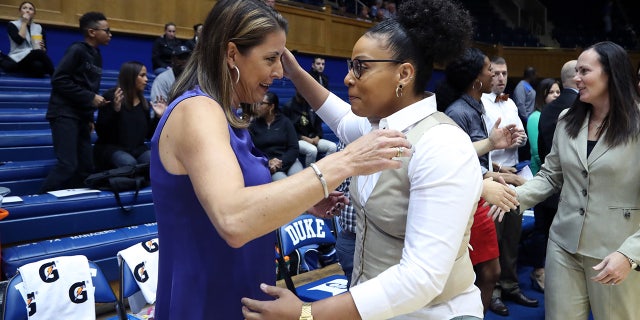 Coach DeUnna Hendrix hugs another coach