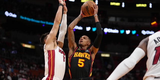 Dejounte Murray #5 of the Atlanta Hawks shoots the ball during the 2023 Play-In Tournament against the Miami Heat on April 11, 2023, at Kaseya Center in Miami, Florida.