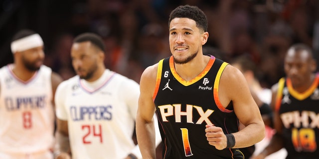 Devin Booker smiles on court