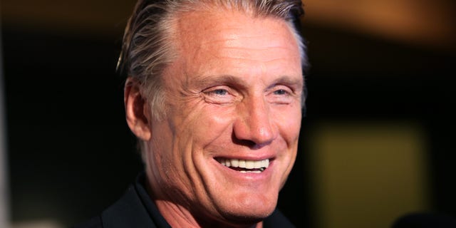 Dolph Lundgren smiles for a photo.