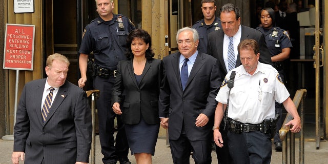 Dominique Strauss-Kahn, center, and his wife, Anna Sinclair, leave the Manhattan Criminal Courthouse after his arraignment hearing on June 6, 2011, in New York City.