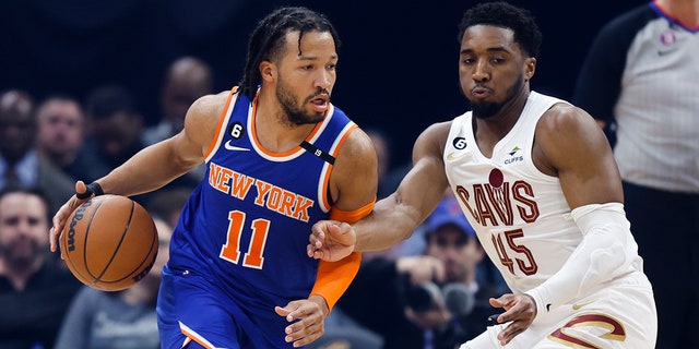 New York Knicks guard Jalen Brunson drives against Cavaliers guard Donovan Mitchell on Friday, March 31, 2023, in Cleveland.