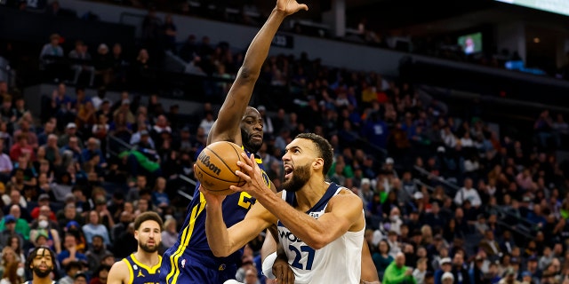Rudy Gobert (27) of the Minnesota Timberwolves drives to the basket against Draymond Green (23) of the Golden State Warriors in the fourth quarter at Target Center Nov. 27, 2022, in Minneapolis.