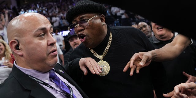 Rapper E-40 is escorted from courtside seating during the Western Conference playoff game between the Golden State Warriors and Sacramento Kings at the Golden 1 Center on April 15, 2023.