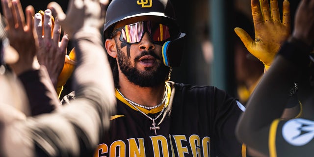 Fernando Tatis Jr. of the San Diego Padres celebrates in the dugout after hitting a home run during a spring training game against the Los Angeles Angels on March 24, 2023, in Tempe, Arizona.