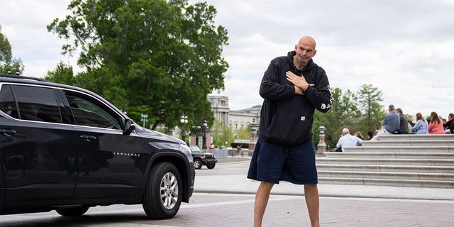 Sen. John Fetterman gestures to reporters as he arrives at the U.S. Capitol on April 17, 2023.