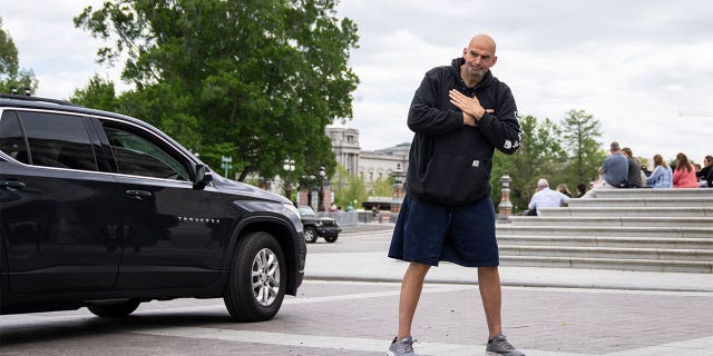 Sen. John Fetterman gestures to reporters as he arrives at the U.S. Capitol on April 17, 2023.