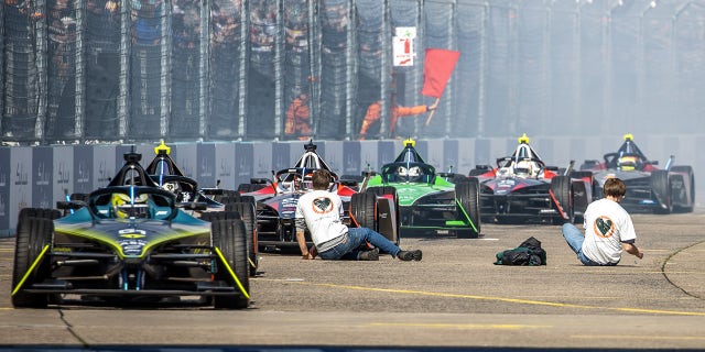 Climate activists interrupt a race