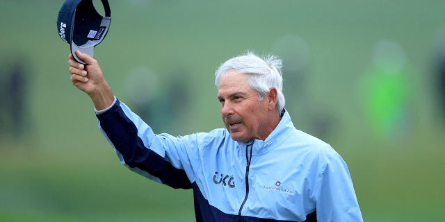 Fred Couples waves as he walks off the 18th green during the completion of the weather-delayed second round of the Masters Tournament at Augusta National Golf Club on April 8, 2023.