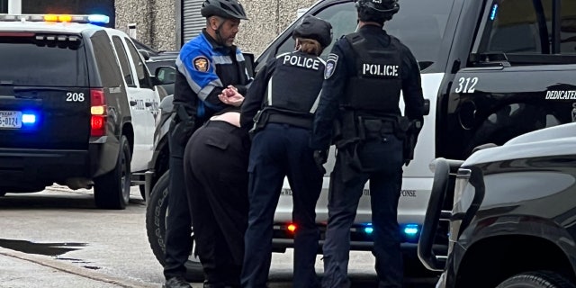 Police arresting suspect at all-ages drag brunch protest