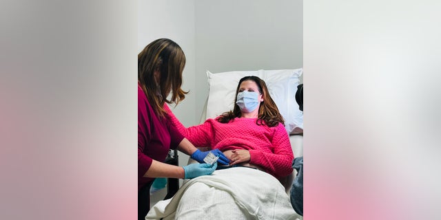 Davis (shown here with mask on) looks forward to a time when more women will have access to the vaccine — not just those who have already been treated for triple-negative breast cancer, but also healthy women who want to prevent cancer from developing in the first place.