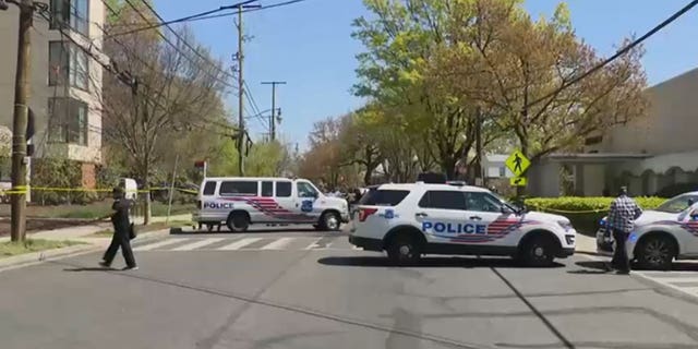 Police units block the street near Stewart Funeral Home after a mass shooting in Washington, D.C., on Tuesday.