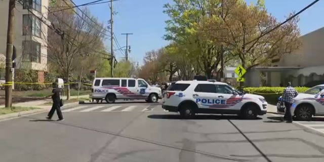 Police units block the street near Stewart Funeral Home after a mass shooting in Washington, D.C., on Tuesday.