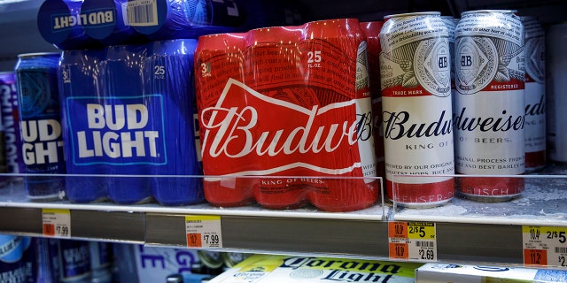 NEW YORK, NY - JULY 26: Cans of Budweiser and Bud Light sit on a shelf for sale at a convenience store in New York City. 