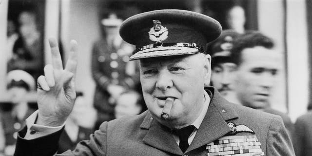 Winston Churchill (1874-1965) gives his famous v-sign as he opens the new headquarters of 615 (County of Surrey) Squadron of the RAAF (Royal Auxiliary Air Force) at Croydon, 1948. 