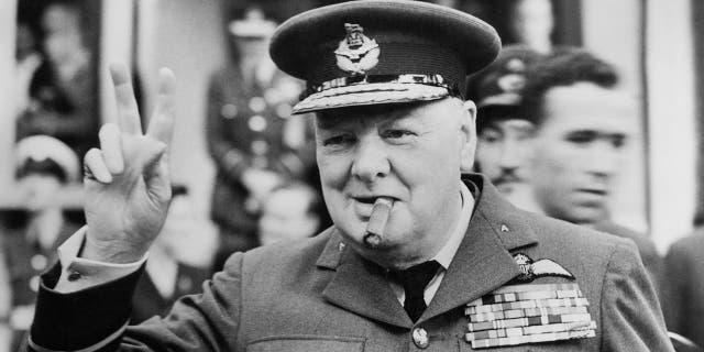 Winston Churchill (1874-1965) gives his famous v-sign as he opens the new headquarters of 615 (County of Surrey) Squadron of the RAAF (Royal Auxiliary Air Force) at Croydon, 1948. 