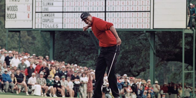 Tiger Woods celebrates after sinking a 4-foot putt to win the U.S. Masters Golf Tournament with a record low score of 18 under par on April 13, 1997, at the Augusta National Golf Club in Augusta, Georgia.