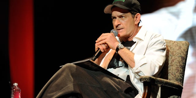 Charlie Sheen wears a #winning hat on stage