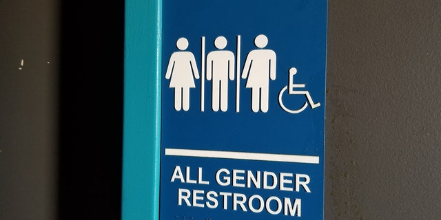 Close-up of sign for all gender restroom in Dublin, California, with male, female and gender-inclusive stick figure illustrations, March 13, 2019.